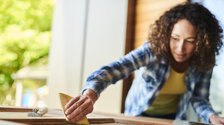 Woman using sandpaper