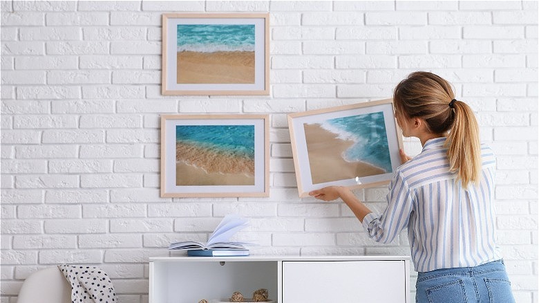 Woman hanging ocean photographs