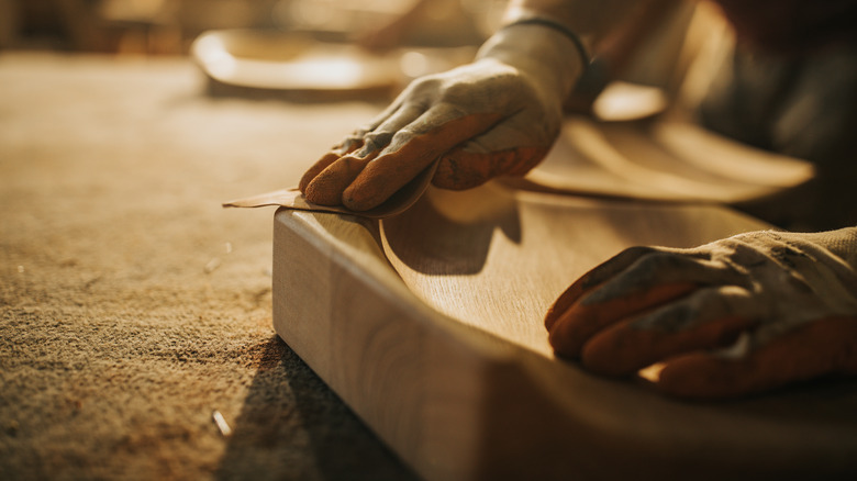 Man sanding curved wood