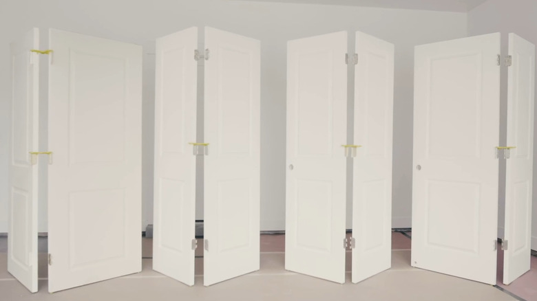 This photo shows eight interior doors held in a standing zig-zag arrangement to make painting easier.