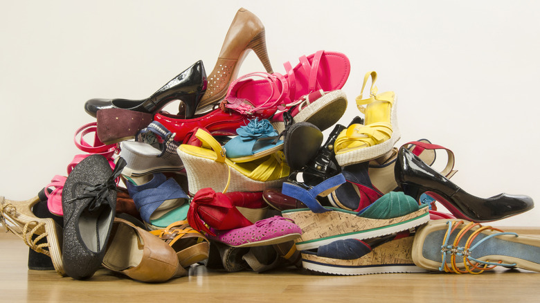 a large disorganized pile of womens shoes