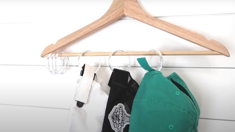 Hats hung up on wall using shower curtain rings