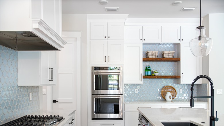 white kitchen with pale blue backsplash