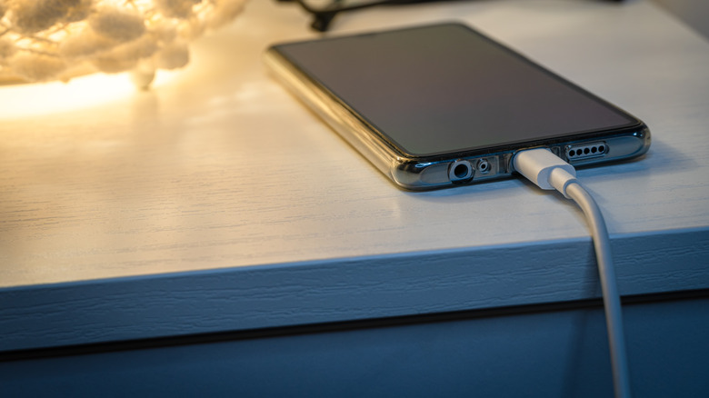 Smartphone charging on a nightstand