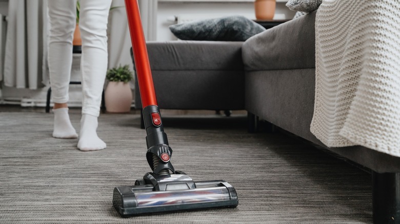 Woman vacuuming carpet