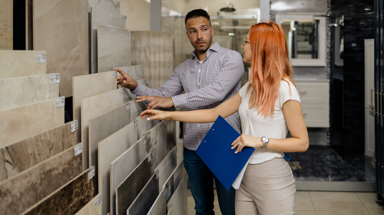 Two people looking at tile options