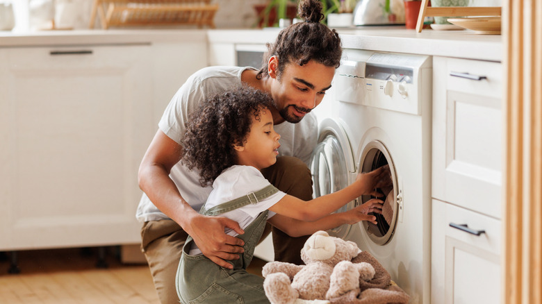 man and child doing laundry