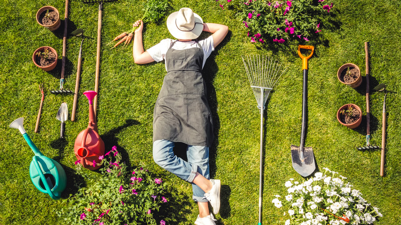 Gardener relaxing with tools