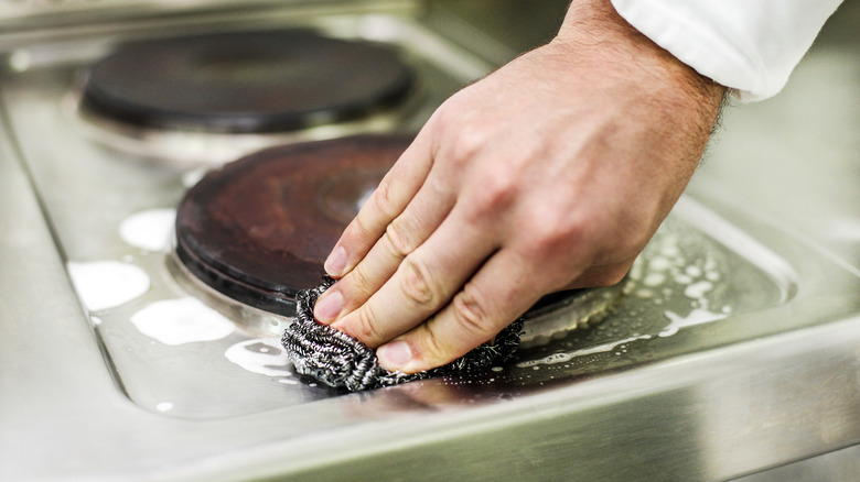 person scrubbing with steel wool