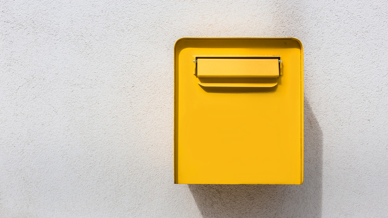 Yellow mailbox on wall