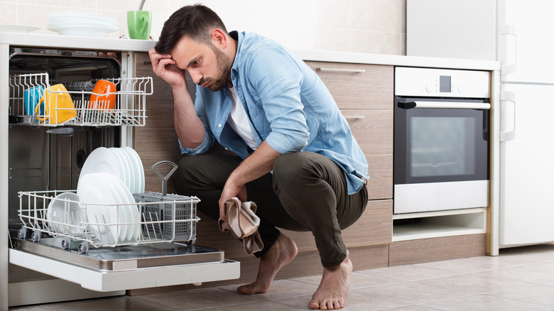 Man emptying dishwasher