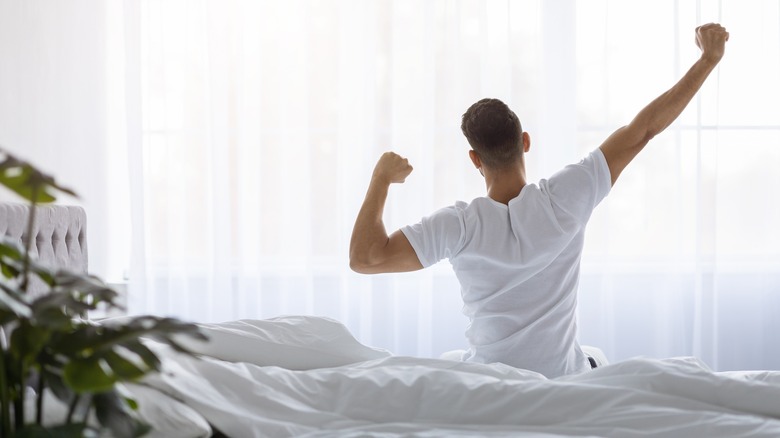 Man stretching after good sleep