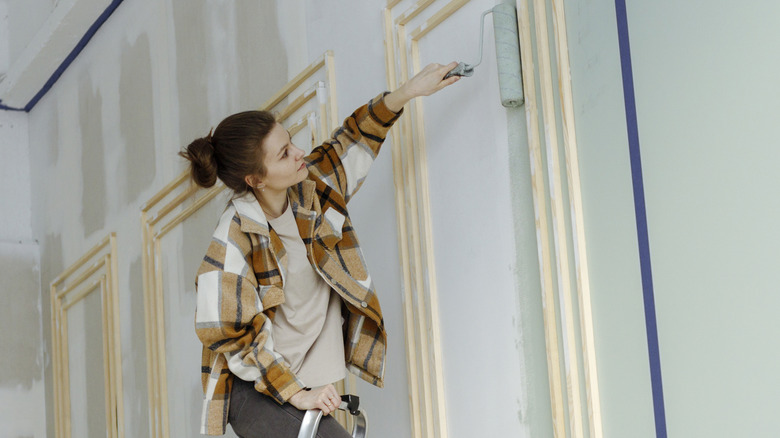 Woman painting wall