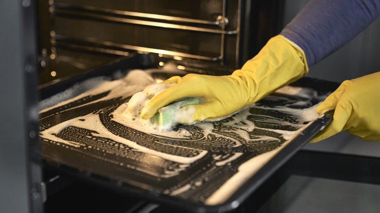 Person cleaning oven