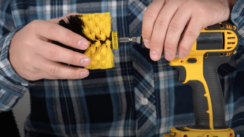 Man installs drill scrub brush