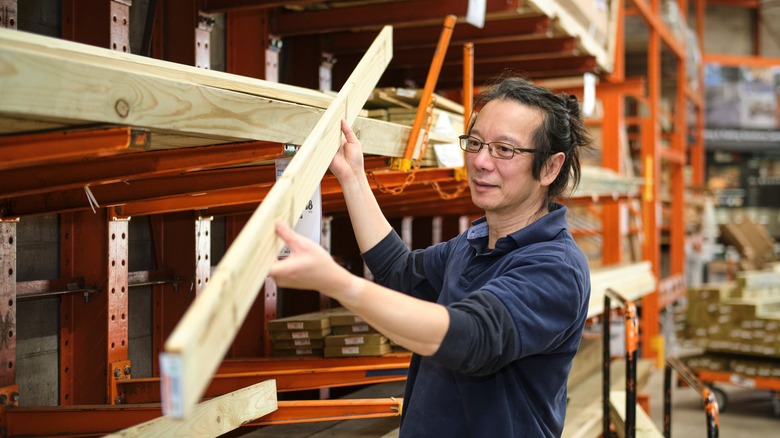 Man holding a wooden plank