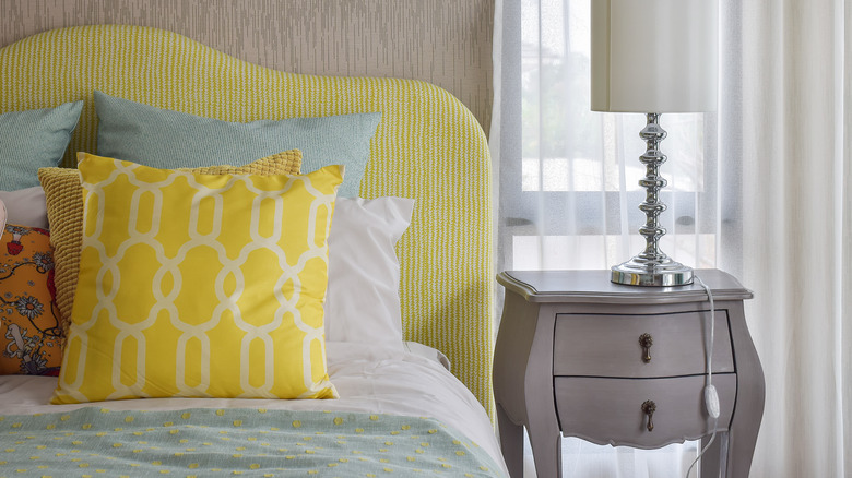 yellow fabric headboard in bedroom