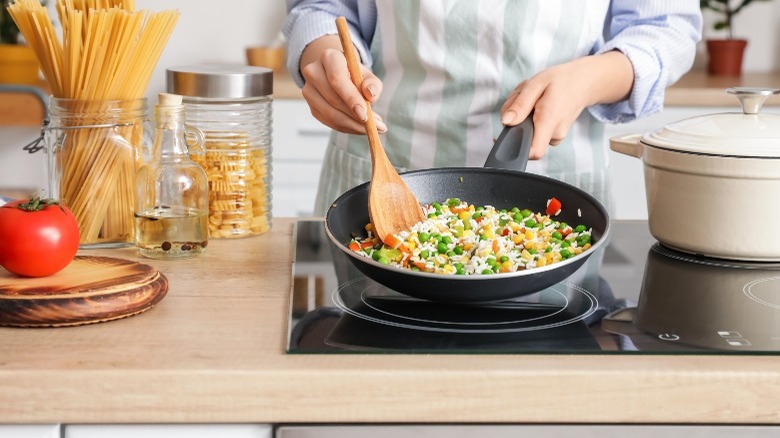 Woman cooking on electric stove 