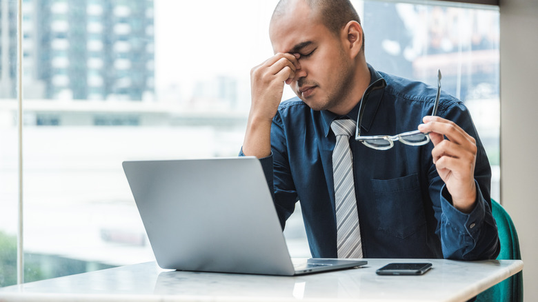 man working not feeling well