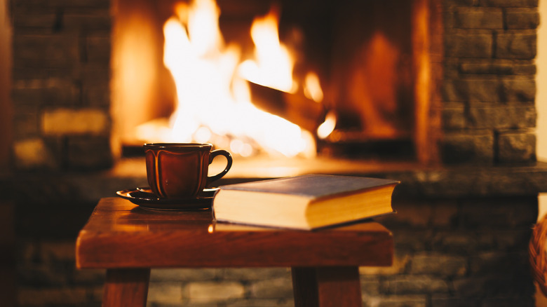 A coffee table by a real fireplace