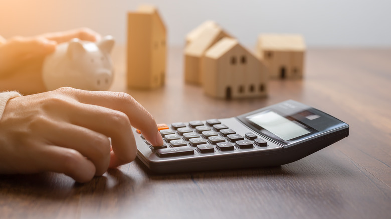 calculator and piggy bank on table