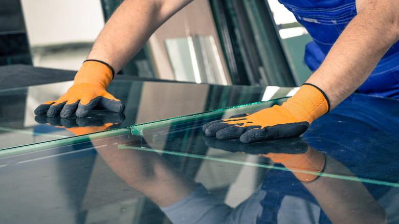 Man repairing glass table 