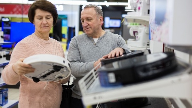 couple shopping for robot vacuum