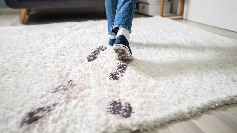 muddy footprints on rug