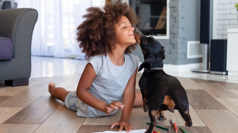 girl with dog on floor