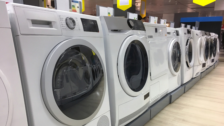 row of white laundry appliances