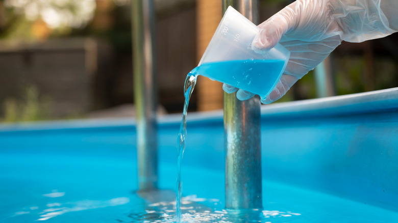 person purifying pool water