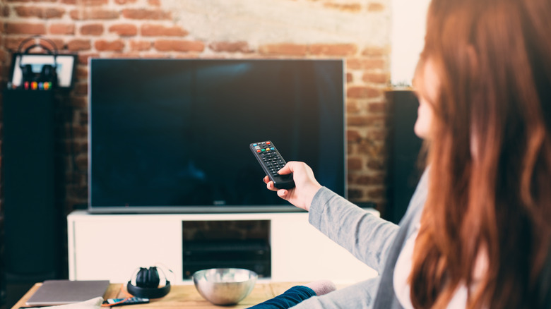 Woman with TV and remote
