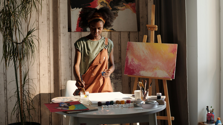 Woman painting on table