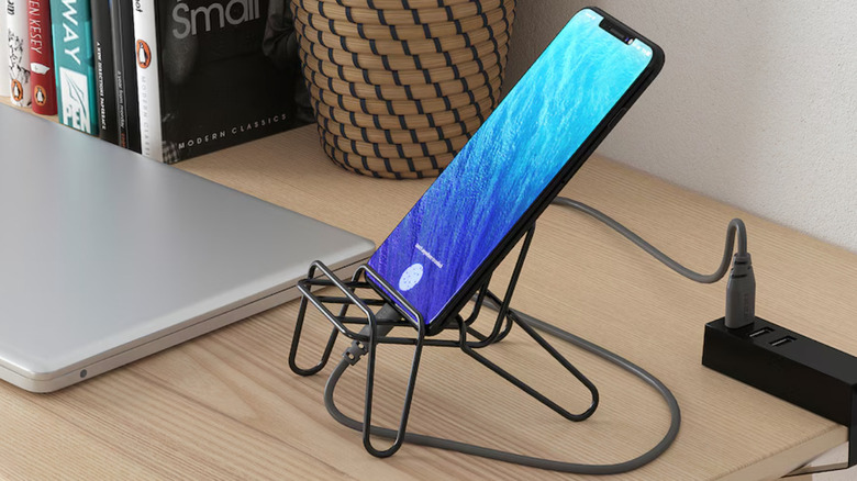 black phone holder on desk