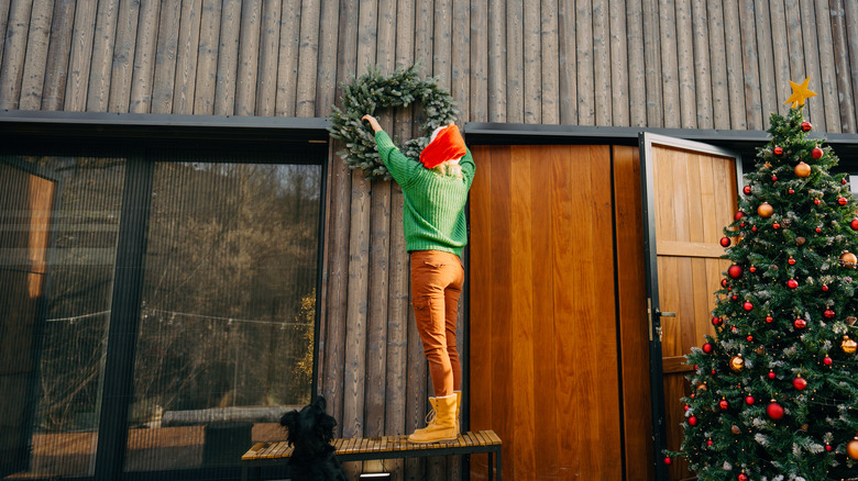 Woman hanging wreath