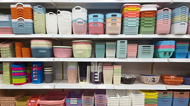 Colorful plastic storage baskets are displayed on shelves