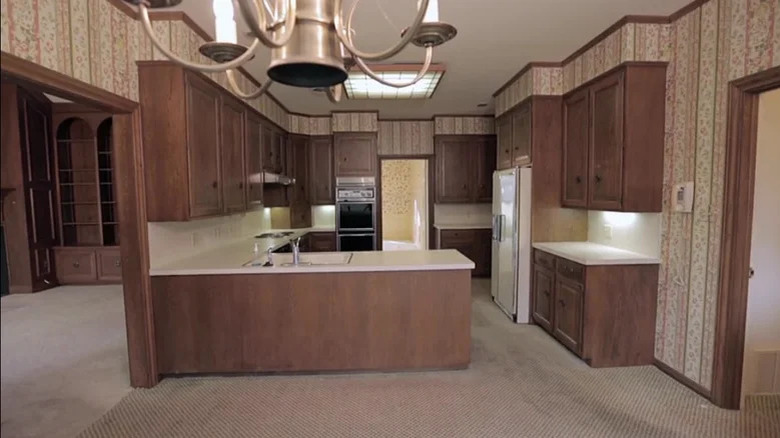 outdated kitchen with brown carpeting 