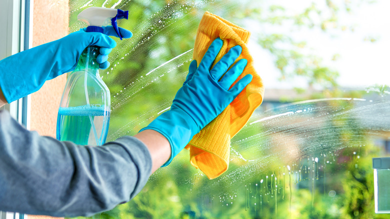 Woman cleaning window