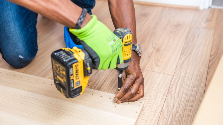 man making wooden pegboard