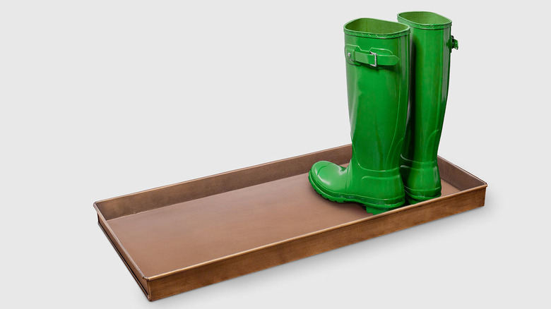 brass tray with green boots