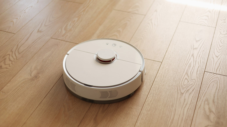 Top view of a robot vacuum on a wooden floor