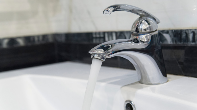 Water flows out of a tap