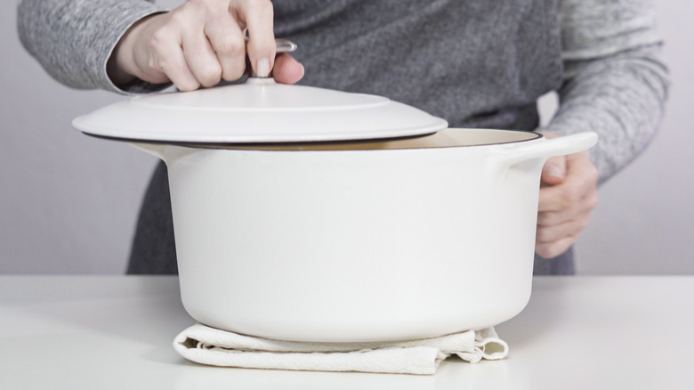 Man holding a Dutch oven lid