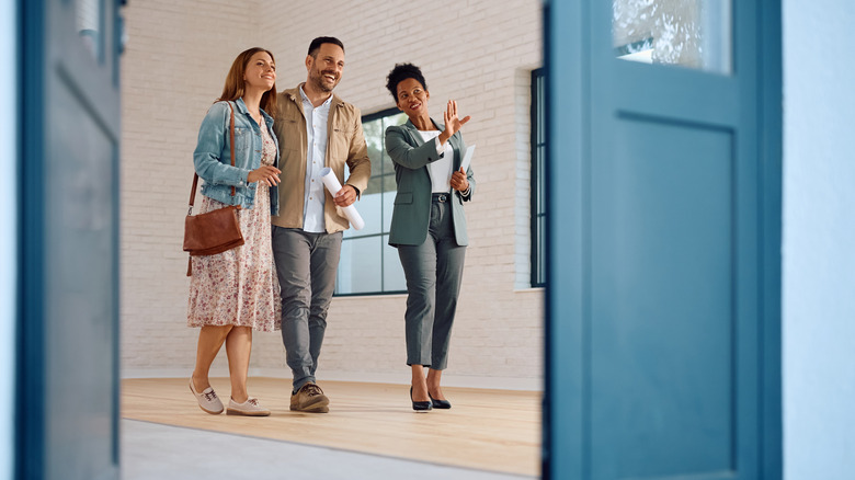 Realtor shows a couple a home for sale