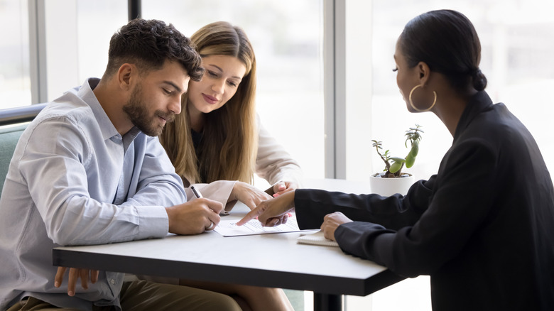 A couple meets with a mortgage lender