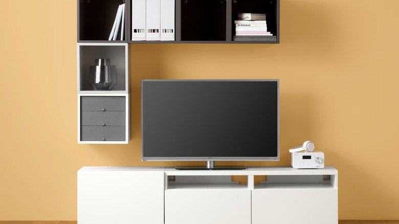 An IKEA BESTÅ storage system with a TV on it