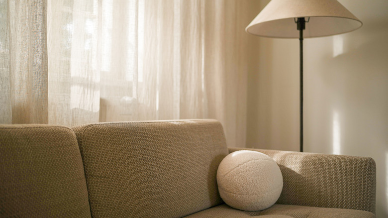 Living room styled with light filtering white curtains