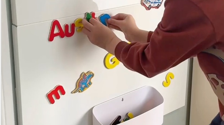 kid using magnet board