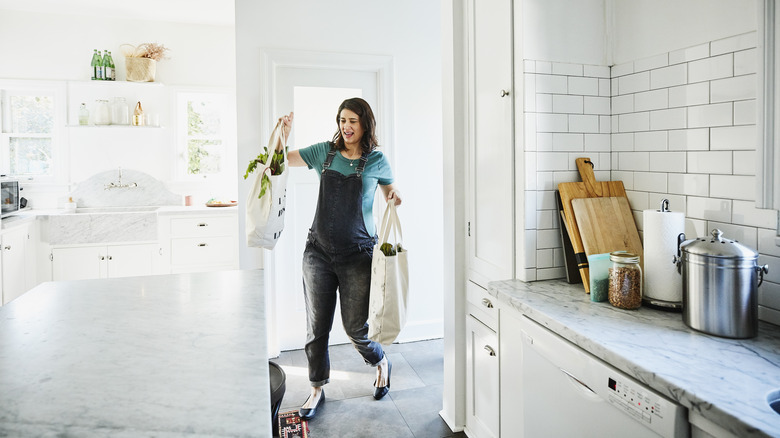 person struggling with groceries