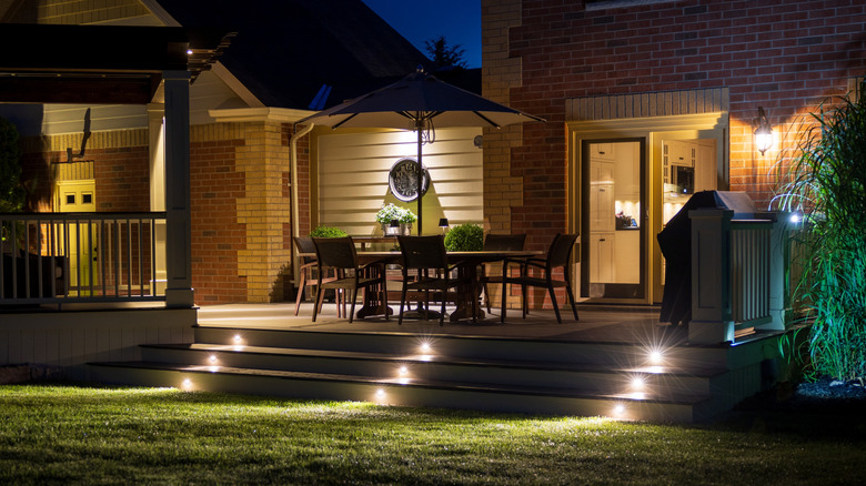 House with patio step lights going into a garden.